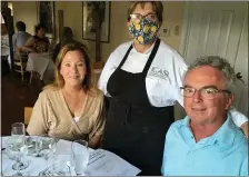  ??  ?? Loretta Paganini welcomes Mary and Tim Hurley of Mentor to a recent wine dinner at Sapore. The Hurleys traveled with her to Sicily in 2015.