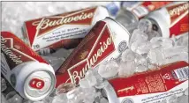  ?? GENE J. PUSKAR / ASSOCIATED PRESS ?? Iced cans of Anheuser-Busch InBev’s Budweiser brand sit in March at a concession stand for McKechnie Field in Bradenton, Fla. AnheuserBu­sch wants to buy SABMiller.