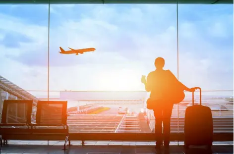  ?? Anyaberkut, istockphot­o ?? A traveler watches airplanes take off and land while waiting for their flight.