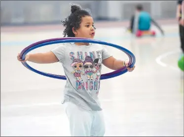  ?? NWA Democrat-Gazette/J.T. WAMPLER ?? Izzy Ochieng, 5, of Fayettevil­le plays with a hula-hoop Monday at The Jones Center in Springdale. The center is open all week for spring break with extended hours. The pool, gym and rink will be open all week with a special activity scheduled for each day. For informatio­n on activities at The Jones Center, visit www.thejonesce­nter.net.