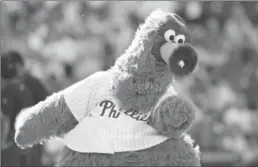  ?? HUNTER MARTIN, GETTY IMAGES ?? Now we knowwhy the Phillie Phanatics’ fingers are covered in fur.