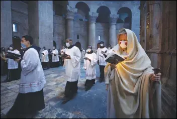  ?? ASSOCIATED PRESS ?? Priests circle the Edicule during Easter Sunday Mass led by the Latin Patriarch at the Church of the Holy Sepulchre, where many Christians believe Jesus was crucified, buried and rose from the dead, in the Old City of Jerusalem.