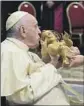  ?? Vatican Media ?? POPE Francis kisses a statue of baby Jesus during Christmas Eve Mass in St. Peter’s Basilica.