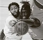  ?? Pool / Getty Images ?? Anthony Davis, left, who scored a game-high 31 points, fights Wenyen Gabriel for a rebound.