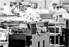  ??  ?? Employees are seen at a circuit board assembly factory. With the global semiconduc­tor industry expected to record another healthy year, driven by the rapid expansions of the IoT industry, analysts viewed Malaysia’s E&amp;E sector as “well positioned” in this highly demanding global tech supply chain. — Reuters photo