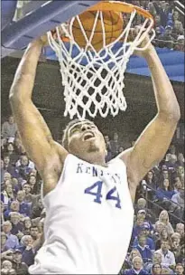  ?? AP ?? Kentucky's Dakari Johnson throws one down as the Wildcats beat North Carolina on Saturday in Lexington after injured teammate Alex Poythress delivers pregame speech.
