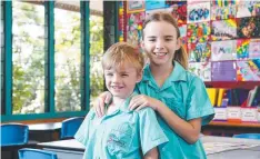  ?? Picture: BRENDAN RADKE ?? GO TIME: St Andrew's Catholic College students Edward Mangan, 6, and Emma Mangan, 9, are back in class today.