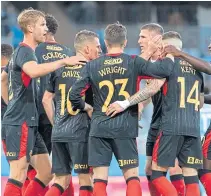  ??  ?? Rangers celebrate Steven Davis’ late goal in Malmo