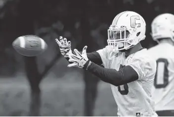  ?? STAFF PHOTOS BY DOUG STRICKLAND ?? Wide receiver Bingo Morton does a passing drill during UTC’s first spring practice Saturday at Scrappy Moore Field.