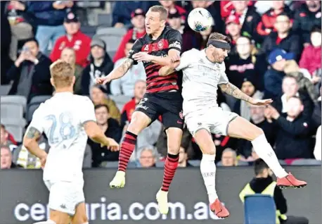  ?? PETER PARKS/AFP ?? Leeds United’s Stuart Dallas (right) fights for the ball with Duke Mitchell of Western Sydney Wanderers during their pre-season friendly football match at Bankwest Stadium in Sydney on July 20.