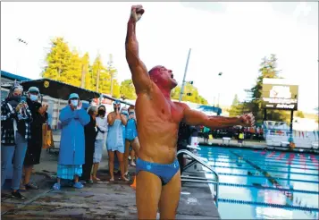  ?? ARIC CRABB – STAFF PHOTOGRAPH­ER ?? David Miller, 59, celebrates after completing his yearlong, phased in 1 million-yard swim on Sunday at the Soda Aquatic Center in Moraga. He raised more than $50,000 for the Cancer Research Institute.