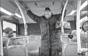  ?? The New York Times/HEATHER WALSH ?? Home health aide Delrisa Sewell-Henry stands while riding on the second of two buses she takes to reach her day’s first assignment in the Springfiel­d Gardens neighborho­od of Queens last month.