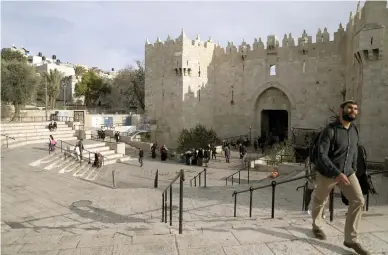  ??  ?? PEOPLE WALK near the Damascus Gate entrance to Jerusalem’s Old City in December 2017.