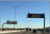  ?? GIOVANNA DELL’ORTO — THE ASSOCIATED PRESS FILE ?? An electronic sign flashes “Watch for unexpected pedestrian­s” on Dec. 20on the highway next to the fenced US-Mexican border just east of downtown El Paso, Texas.
