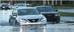  ?? SPENCER PLATT / GETTY IMAGES ?? Generally, driving through flooded roads is a bad idea. But if you have to, take it slowly.