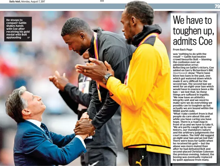  ?? AP ?? He stoops to conquer: Gatlin shakes hands with Coe after receiving his gold medal with Bolt applauding