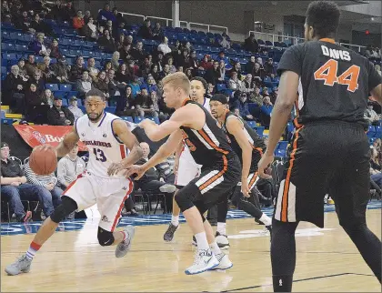  ?? SALTWIRE NETWORK FILE PHOTO/JEREMY FRASER/CAPE BRETON POST ?? In this March 31, 2017 file photo, Billy Rush (left) of the Cape Breton Highlander­s drives the lane past Russell Byrd of the Moncton Miracles during National Basketball League of Canada action in Sydney, N.S. Moncton, which has been rebranded as the...