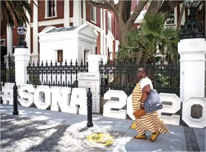  ?? Picture: Jacques Nelles ?? BIG DAY. A woman passes a Sona 2020 sign outside parliament in Cape Town during preparatio­ns for the State of the Nation address taking place today.