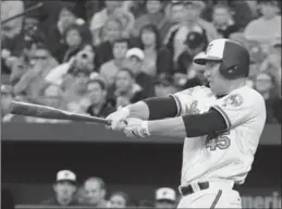  ?? KENNETH K. LAM, TNS ?? Baltimore Orioles Mark Trumbo launched himself in to the history books.