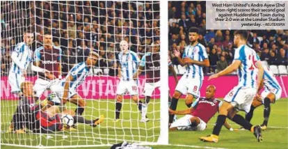  ?? – REUTERSPIX ?? West Ham United’s Andre Ayew (2nd from right) scores their second goal against Huddersfie­ld Town during their 2-0 win at the London Stadium yesterday.