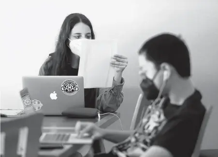  ?? KAITLIN MCKEOWN/STAFF PHOTOS ?? Roadstead Montessori High School students Maya Mirkova Livni and Henry Foster work to transcribe ship manifests from Norfolk’s slave trade before the end of the Civil War.