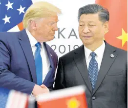  ?? AP ?? In this June 29, 2019, file photo, President of the United States Donald Trump (left) shakes hands with President of China Xi Jinping during a meeting on the sidelines of the G-20 summit in Osaka, western Japan.