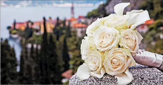  ?? GETTY PHOTOS ?? One wedding planner says clients like Italy’s Lake Como for tying the knot. The lake is seen here from a lofty vantage point overlookin­g the picturesqu­e village of Varenna.