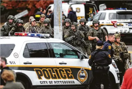  ?? Photos by Alexandra Wimley / Associated Press ?? Law enforcemen­t officers secure the scene Saturday at the Tree of Life Congregati­on in Pittsburgh where a shooter opened fire.