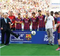  ?? (Reuters) ?? SHIMON PERES kicks a soccer ball to Barcelona superstar Lionel Messi (right) during the Spanish club’s ‘Peace Tour’ trip to Israel in the summer of 2013.