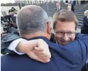  ?? TONY DEJAK/AP ?? Attorney Mark Lanier gets a hug outside Cleveland’s federal courthouse after a settlement scuttled plans for a trial on an opioid lawsuit.