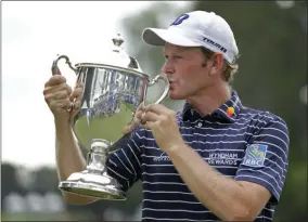  ?? CHUCK BURTON — THE ASSOCIATED PRESS ?? In this file photo, Brandt Snedeker kisses the trophy after winning the Wyndham Championsh­ip golf tournament at Sedgefield Country Club in Greensboro, N.C.