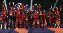  ?? LAURENCE GRIFFITHS — POOL PHOTO VIA AP, FILE ?? In this July 22, 2020, file photo, Liverpool’s Jordan Henderson lifts the English Premier League trophy following their soccer match against Chelsea at Anfield Stadium in Liverpool, England.