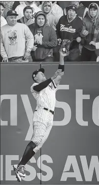  ?? Michael Ciaglo/HOUSTON CHRONICLE VIA AP ?? Yankees right fielder Aaron Judge leaps to snag a fly ball by Astros designated hitter Yuli Gurriel during the fourth inning of Game 3 of the ALCS on Monday in New York. New York won 8-1 and trails in the series 2-1.