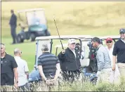  ?? PETER MORRISON — THE ASSOCIATED PRESS ?? President Donald Trump waves to protesters while playing golf at Turnberry Golf Club in Scotland Saturday.