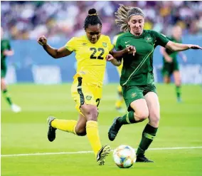  ??  ?? Mireya Grey (left) of the Reggae Girlz goes on the attack under pressure from Australia’s Karly Roestbakke­n in the Jamaica vs Australia fixture of the FIFA Women’s World Cup 2019 at Stade des Alpes in Grenoble, France, on Tuesday June 18, 2019.