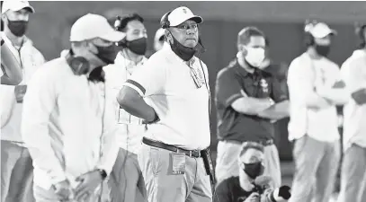  ?? PAUL W. GILLESPIE/CAPITAL GAZETTE ?? Navy football coach Ken Niumatalol­o, seen looking toward the scoreboard during a game against Houston on Oct. 24, dismissed the rumors that he was considerin­g leaving for the University of Arizona.