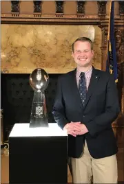  ?? COURTESY PHOTO ?? While serving as a state representa­tive in 2018, Eric Roe enjoys a moment with the Lombardi Trophy at the Pennsylvan­ia State Capitol in Harrisburg.
