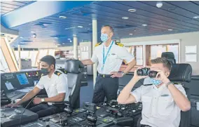  ??  ?? ABOVE
Captain Robert Bodin and his deck officers aboard the cruise ship ‘World Dream’, in waters off Malaysia.