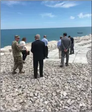  ?? BY ANDREW CASS ACASS@NEWS-HERALD.COM @ANDREWCASS­NH ON TWITTER ?? U.S. Army Corps of Engineers Buffalo District Lt. Col. Jason Toth (back left) gives a tour of the completed revetment wall protecting the Lake County Raw Water Pump Station in Painesvill­e Township from erosion.