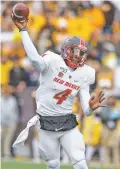  ?? MICHAEL SMITH/ASSOCIATED PRESS ?? New Mexico quarterbac­k Sheriron Jones throws a pass against Wyoming during an Oct. 19 game in Laramie, Wyo. Jones has been suspended indefinite­ly, coach Bob Davie announced Tuesday. Davie did not disclose the reason for the suspension.