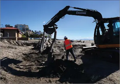  ?? SHMUEL THALER — SANTA CRUZ SENTINEL FILE ?? Geomorphol­ogist David Revell directing efforts to construct storm-resilient dunes with a driftwood core at Rio Del Mar State Beach in 2022. Equipped with additional wood that washed ashore in recent storms, State Parks will lead an effort this week to reinforce the sandy structures experts say were historical­ly part of the local habitat.