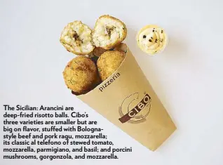  ??  ?? The Sicilian: Arancini are deep-fried risotto balls. Cibo’s three varieties are smaller but are big on flavor, stu ed with Bolognasty­le beef and pork ragu, mozzarella; its classic al telefono of stewed tomato, mozzarella, parmigiano, and basil; and...