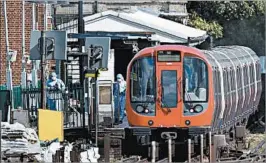  ?? ADRIAN DENNIS/GETTY-AFP ?? Forensics officers work at a platform at Parsons Green station Friday in west London.