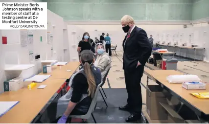  ?? MOLLY DARLINGTON/PA ?? Prime Minister Boris Johnson speaks with a member of staff at a testing centre at De Montfort University