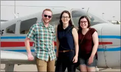  ?? Herald photo by Melissa Villeneuve ?? Pilot Matt White of Excel Flight Training, left, is ready to take Erin Saunders and Jillian Murphy into the sky during the fourth annual Fly Day appreciati­on event for Big Brothers Big Sisters Lethbridge and District.