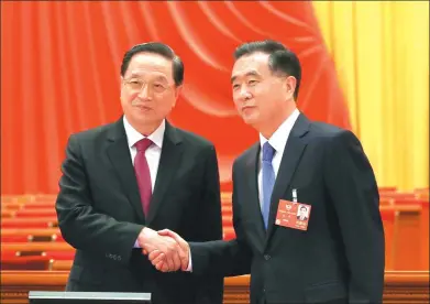  ?? ZOU HONG / CHINA DAILY ?? Wang Yang (right), a member of the Standing Committee of the Political Bureau of the CPC Central Committee who will preside over the first session of the 13th Chinese People’s Political Consultati­ve Conference National Committee, shakes hands in...