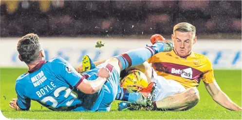  ??  ?? Dundee’s Andrew Boyle and Motherwell’s Alan Campbell both fight hard to gain possession of the ball MoTHErWEll: (3-5-2) Carson 6; Aldred 6, McHugh 6, Hartley 6; Cadden 6, Grimshaw 6, Bigirimana 5 (Sammon 90+2 2), Turnbull 8 (Campbell 79 5 ), Tait 5; Main 4 (Johnson 65 5), Bowman 4. Unused – Gillespie (Gk), Frear, Mbulu, Maguire. DuNDEE: (3-4-3) Hamilton 6; Boyle 5, O’Dea 6 (Inniss 58 5), Kasunga 4; Kerr 6, Spence 5, Kamara 6, C. Miller 5; Curran 5 (Woods 73 4), Moussa 3 (McGowan 73 4) K. Miller 4. Unused - Parish (Gk), Deacon, Mendy,