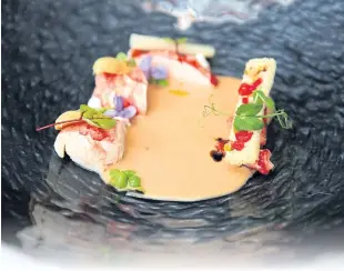  ??  ?? Canadian lobster with white asparagus bisque, lemon crème and pistachio cranberry brioche.