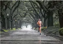  ?? Jon Shapley / Staff photograph­er ?? Andrew Littlefiel­d runs in the rain Saturday along South Boulevard in Houston. He called running his “lifestyle.” The rain is set to end around dawn Sunday, and an arctic air mass will bring temperatur­es near freezing Monday night.