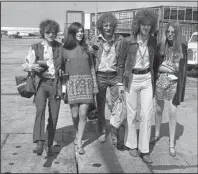  ?? The Associated Press ?? 1967: In this Aug. 20, 1967, file photo, members of the rock group Cream depart from Heathrow Airport in London for their American tour. The trio, walking with unidentifi­ed female companions, from left are, base guitarist Jack Bruce, drummer Ginger Baker, and lead guitarist Eric Clapton. Baker, the volatile and propulsive British musician who was best known for his time with the power trio Cream, died Sunday at age 80, his family said.